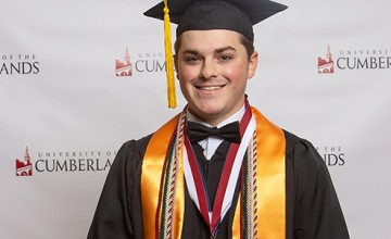 A student wearing a cap and gown