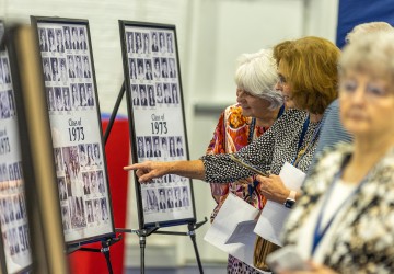 Alumni look at class photos during the 2023 Homecoming celebration