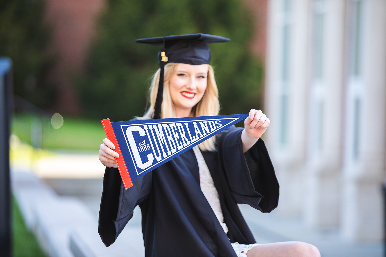 A graduate shows off her Cumberlands pennant 