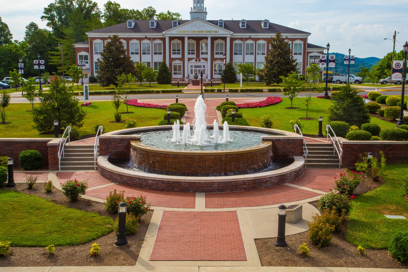 A water fountain in the middle of the college campus. 