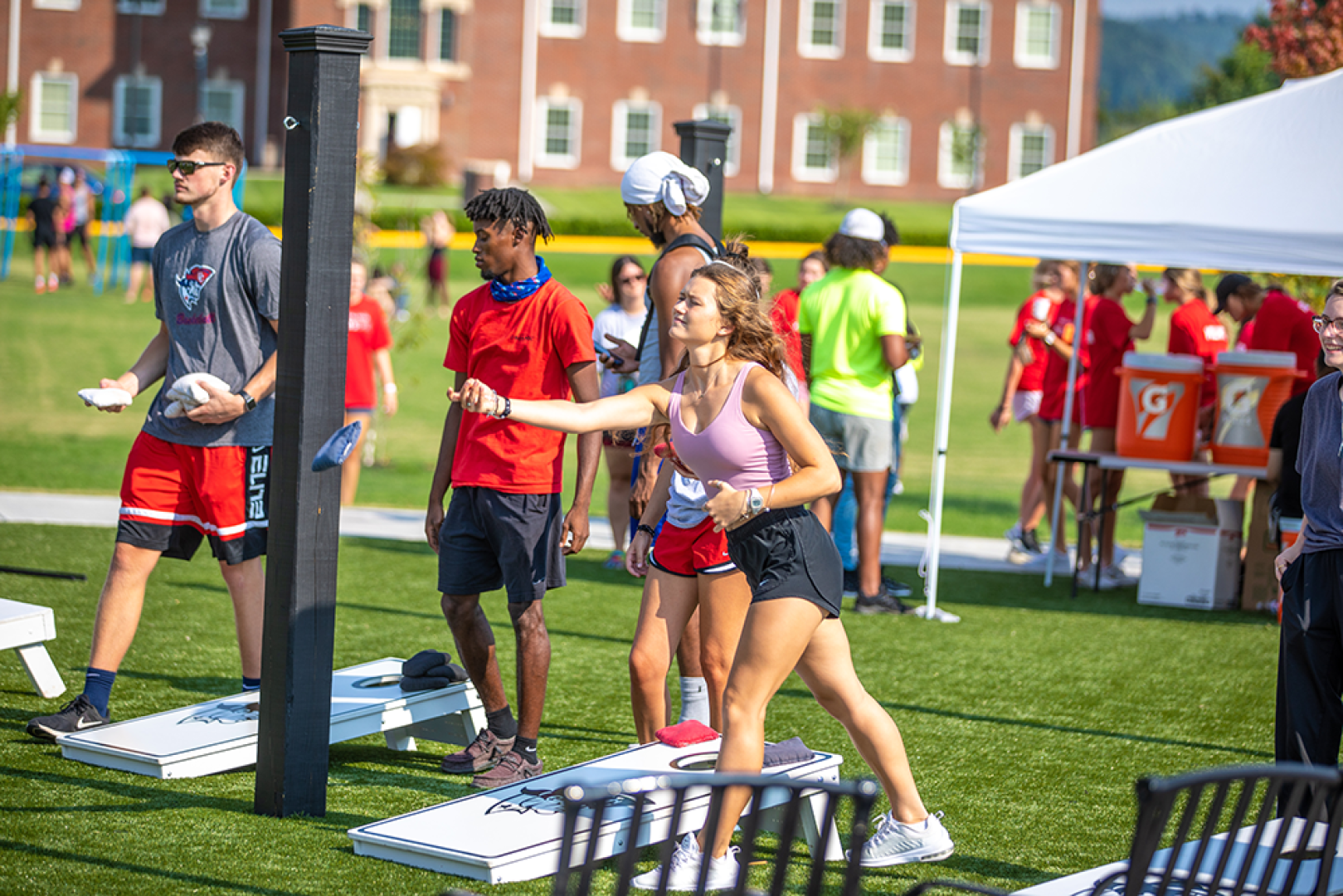 Students playing cornhole at campus event