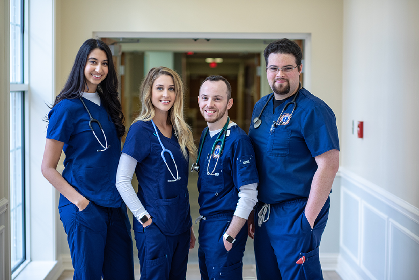 PA students standing together in PA building's hallway. 