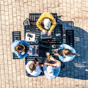An aerial footage of several students studying outside