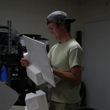 A student placing an item into styrofoam