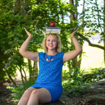 A student balancing books on her head