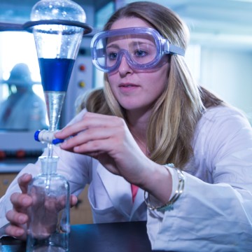 A chemist mixing chemicals
