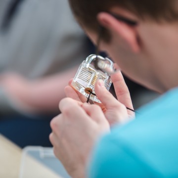 A person picking a padlock