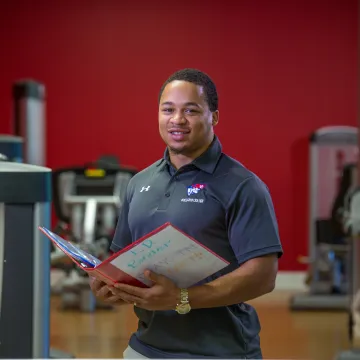 A personal trainer in a gym