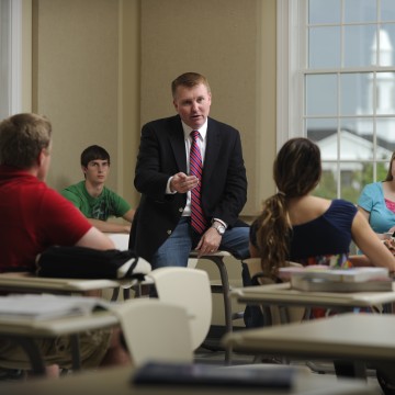 A man speaking to a class 