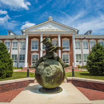 Bronze statue in front of a campus building