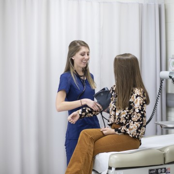 A nurse taking a patient's blood pressure
