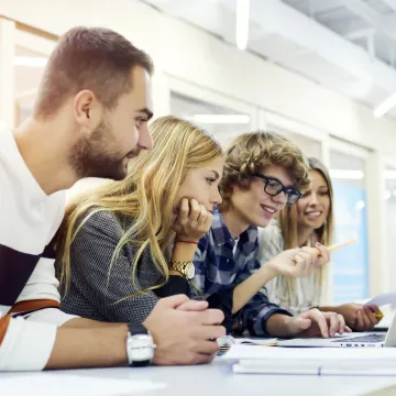 Students looking at a laptop