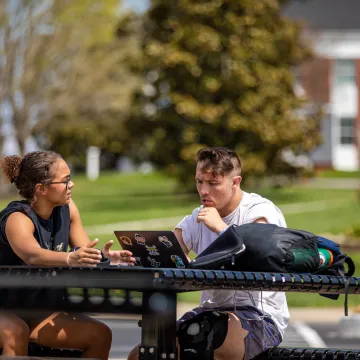 Two students looking at a laptop