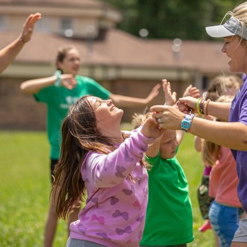 Students leading children in summer camp activities