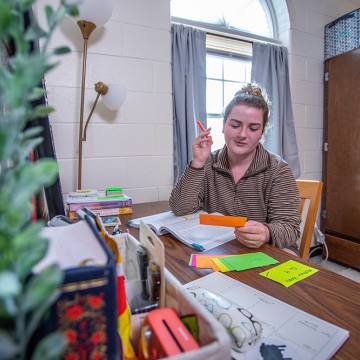 A student studying in their dorm