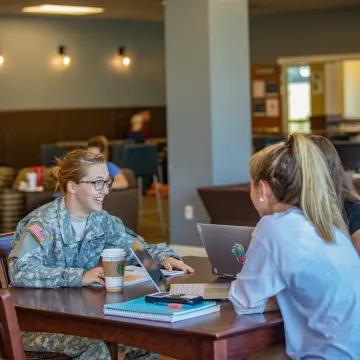 Military cadet speaking with fellow students
