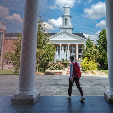 A student walks out of Grace Crum Rollins. 