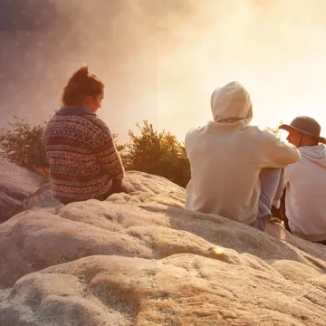 Students watch a sunrise from Chain Rock near campus. 