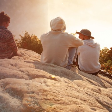 College students take in a sunrise at Chain Rock. 