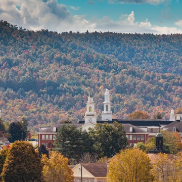 A view of campus depicting several buildings among the autumn foliage. 