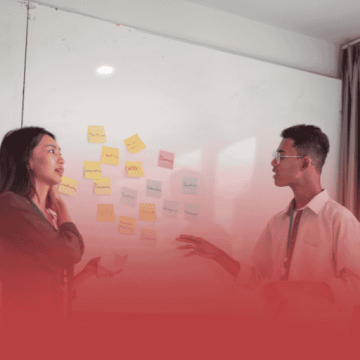 Project Managers Discussing Solutions at a Whiteboard