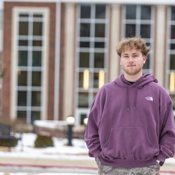 Commuter student Jackson Reece poses for a photo in front of the library. 