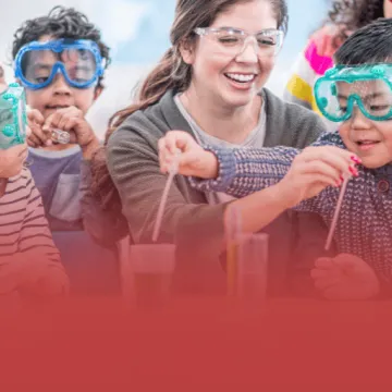 Teacher Working with Students in Science Lab