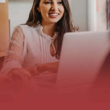 Communications Professional on Laptop with Clients