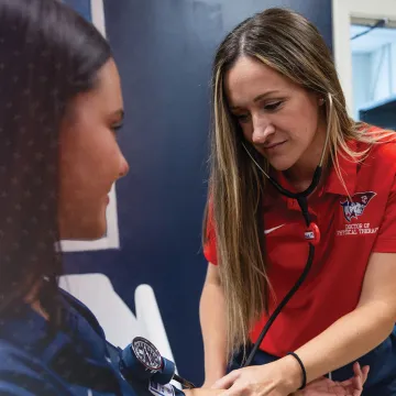 A healthcare student takes the blood pressure of a patient. 