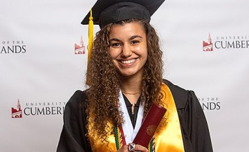 A student wearing a cap and gown