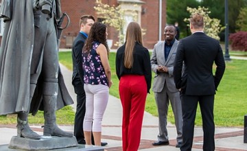 Several people standing outside having a conversation