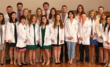 Students wearing physician coats