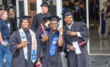 Three students celebrate their graduation at University of the Cumberlands.