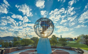 The sun rises behind the globe statue on Cumberlands' campus. 