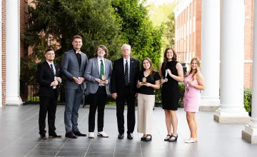 The 2025 academic honors students pose for a photo with President Cockrum.