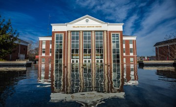 The Rollins Family Learning Center reflecting in the fountain. 