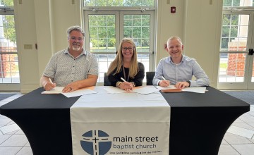 Officials from Main Street Baptist, Williamsburg Independent School, and University of the Cumberlands sign an agreement to operate an early childhood center. 