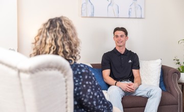 A male student speaks with a counselor during a session at the university's counseling center. 