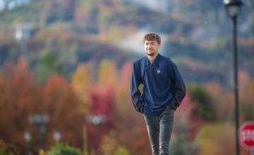 A male Cumberlands student walks across campus on a fall morning. 
