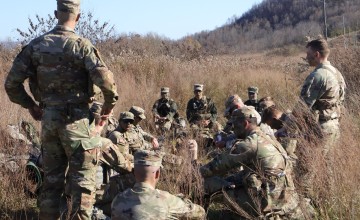 A group of Army ROTC cadets listen to their commander during a field exercise in the fall. 