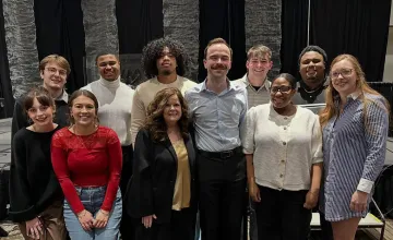 Lisa Bartram stands with a group of students after being recognized by the Association for the Promotion of Campus Activities. 