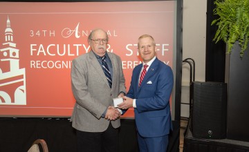 Dr. Tom Frazier is honored at his retirement by President Quentin Young. 