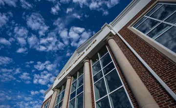 A view of a cloudy sky above the Rollins Family Learning Center. 