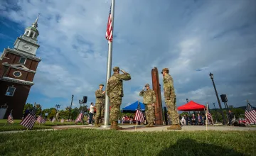 ROTC cadets salute next to the American flag and the 9/11 remembrance memorial on the Cumberlands campus.