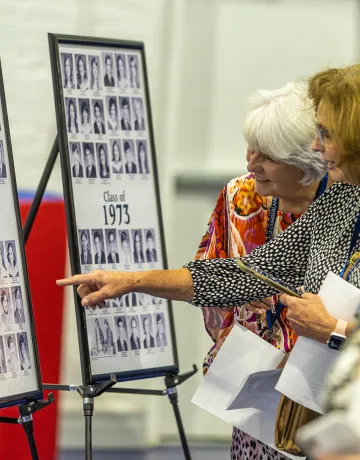Alumni look at class photos during the 2023 Homecoming celebration
