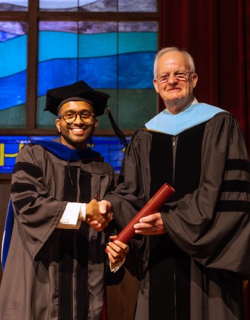 Dr. Sonal Sagar Boda receives his diploma from President Cockrum. 