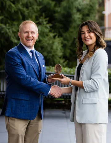 President Young presents an academic award to Joy Kendrick.
