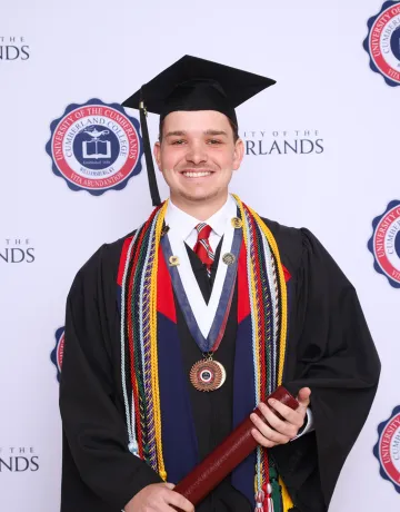 Trey Jackson posing for a graduation photo. 
