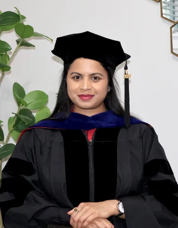 Dr. Saika Anumula posing in her cap and gown. 