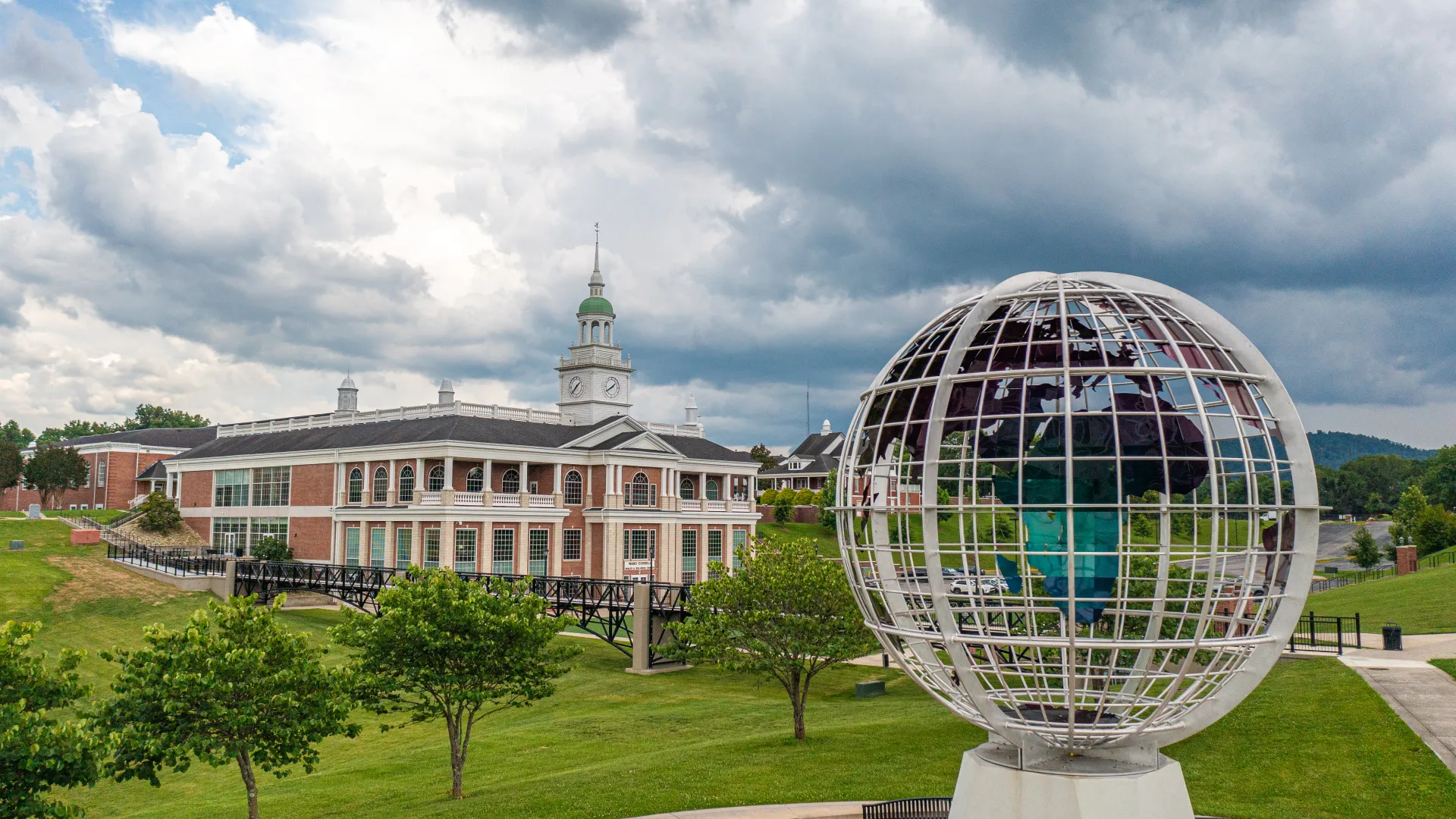Large globe statue in front of campus building